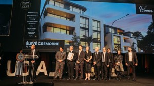 HELM's team on stage accepting their award at the UDIA 2026 gala dinner. 